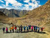 Group celebrating reaching a pass in the Tian Shan mountains |  Lachlan Gardiner