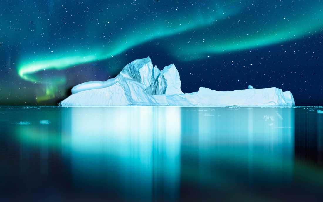 Aurora Borealis lights up the fjord in Greenland